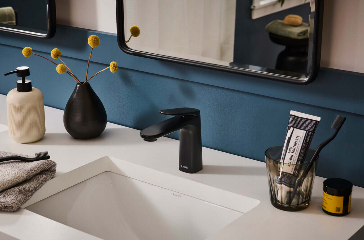 Ruvati RVF5135 Este Single-Handle Bathroom Faucet in Brushed Nickel or Matte Black on vanity with modern decor.