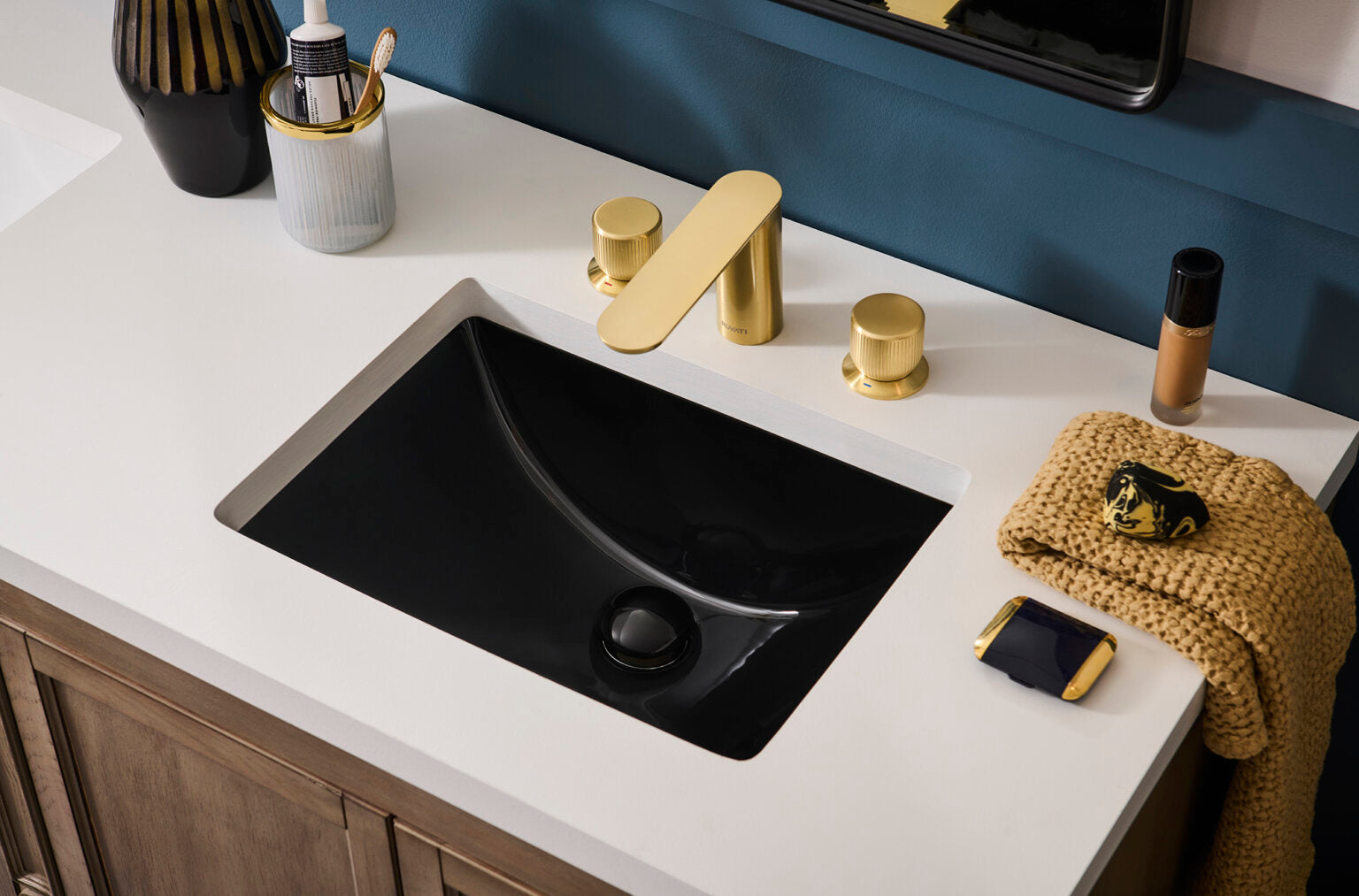 Ruvati RVF5235 Fabio Two-Handle Widespread Bathroom Faucet in Brushed Gold installed over a black sink.