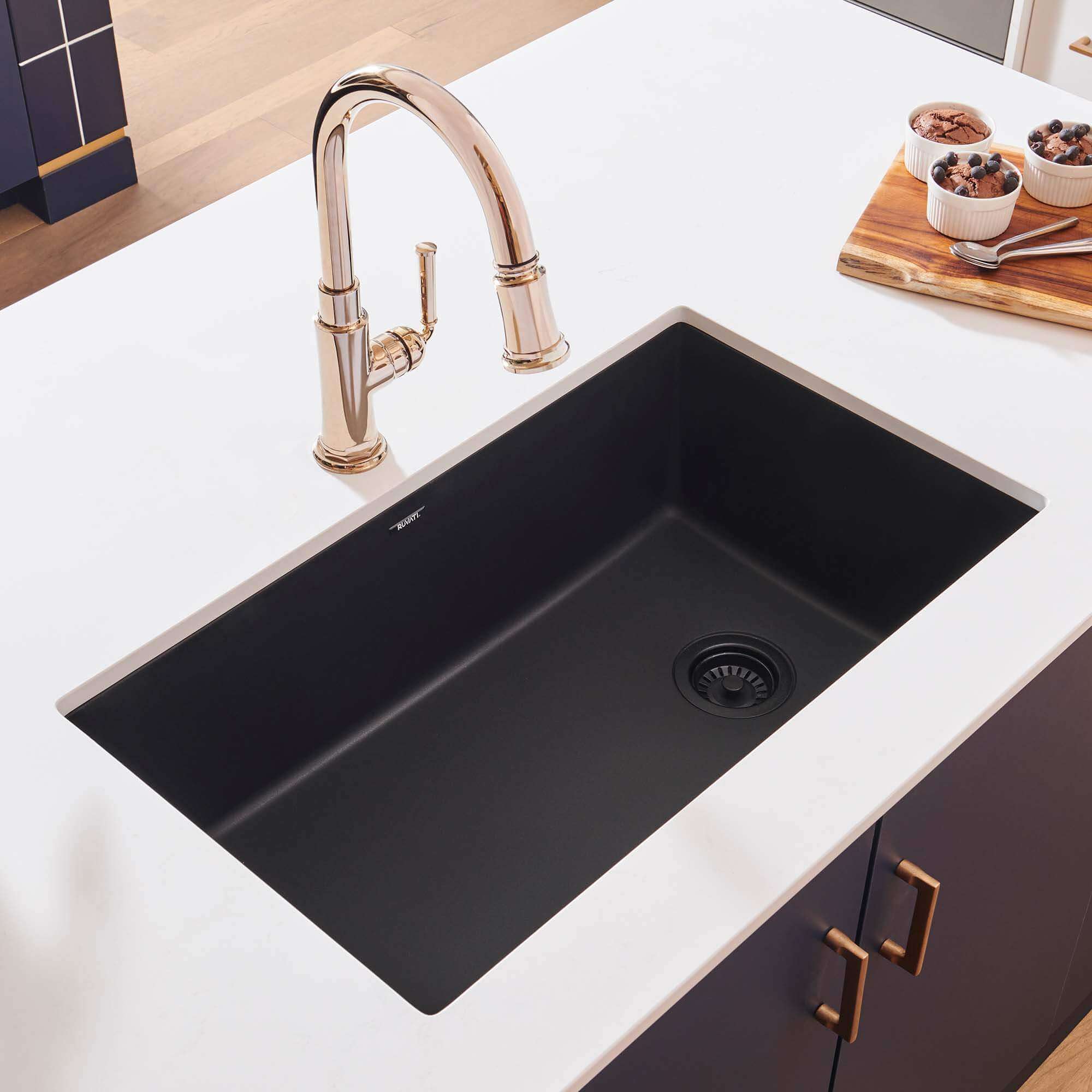 Ruvati 32-inch epiGranite undermount kitchen sink in Midnight Black with a modern faucet and countertop.