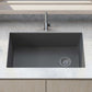 Ruvati 32" epiGranite undermount kitchen sink in Urban Gray in a modern kitchen with countertop and bowl of green apples.