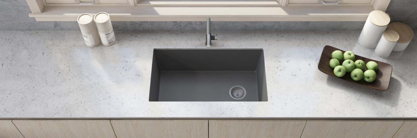 Ruvati 32" epiGranite undermount kitchen sink in Urban Gray in a modern kitchen with countertop and bowl of green apples.
