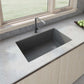 Ruvati 32 inch epiGranite undermount kitchen sink in Urban Gray with modern faucet and wooden cabinetry, showcasing a stylish kitchen setup.