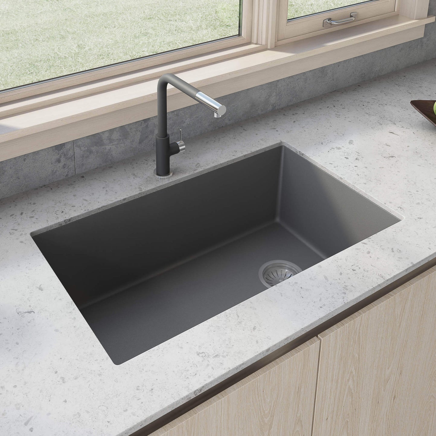 Ruvati 32-inch epiGranite undermount kitchen sink in Urban Gray composite with faucet on a stone countertop.