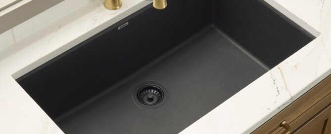 Ruvati 32" epiGranite undermount kitchen sink in Midnight Black with gold faucet in a modern kitchen setting