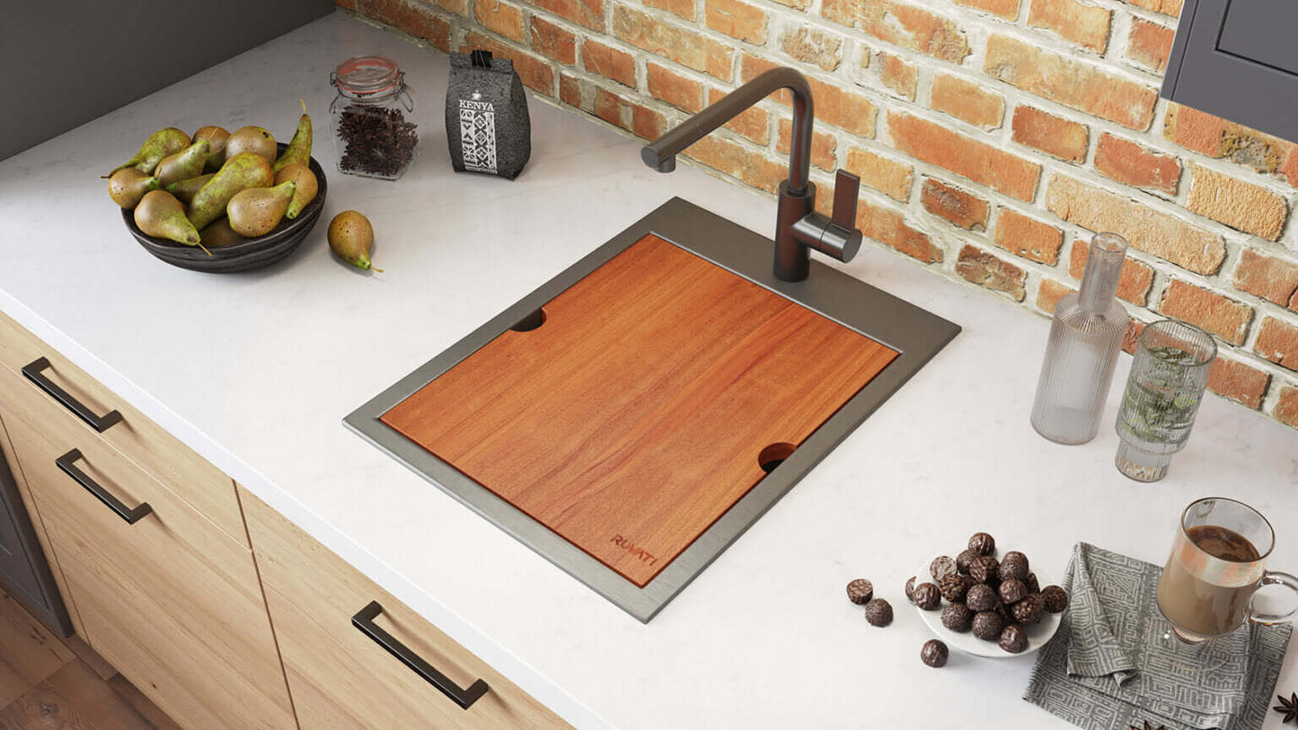 Ruvati 15" x 20" Giana Nano-PVD Workstation Bar Sink Drop-In - RVH8210 with wooden cutting board and modern faucet.