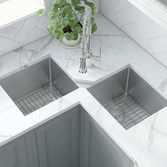 Ruvati Corner Butterfly Undermount Kitchen Sink RVH8400 showcasing a stylish dual-bowl design with grids and a modern faucet.