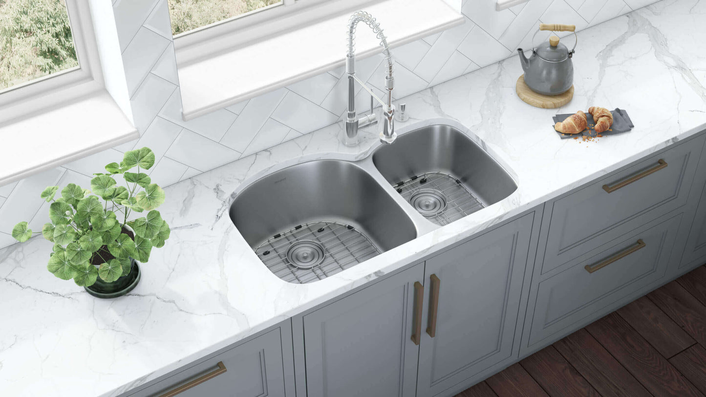 Ruvati 34" Undermount Kitchen Sink 60/40 Double Bowl - RVM4600 installed in a modern kitchen with marble countertop.