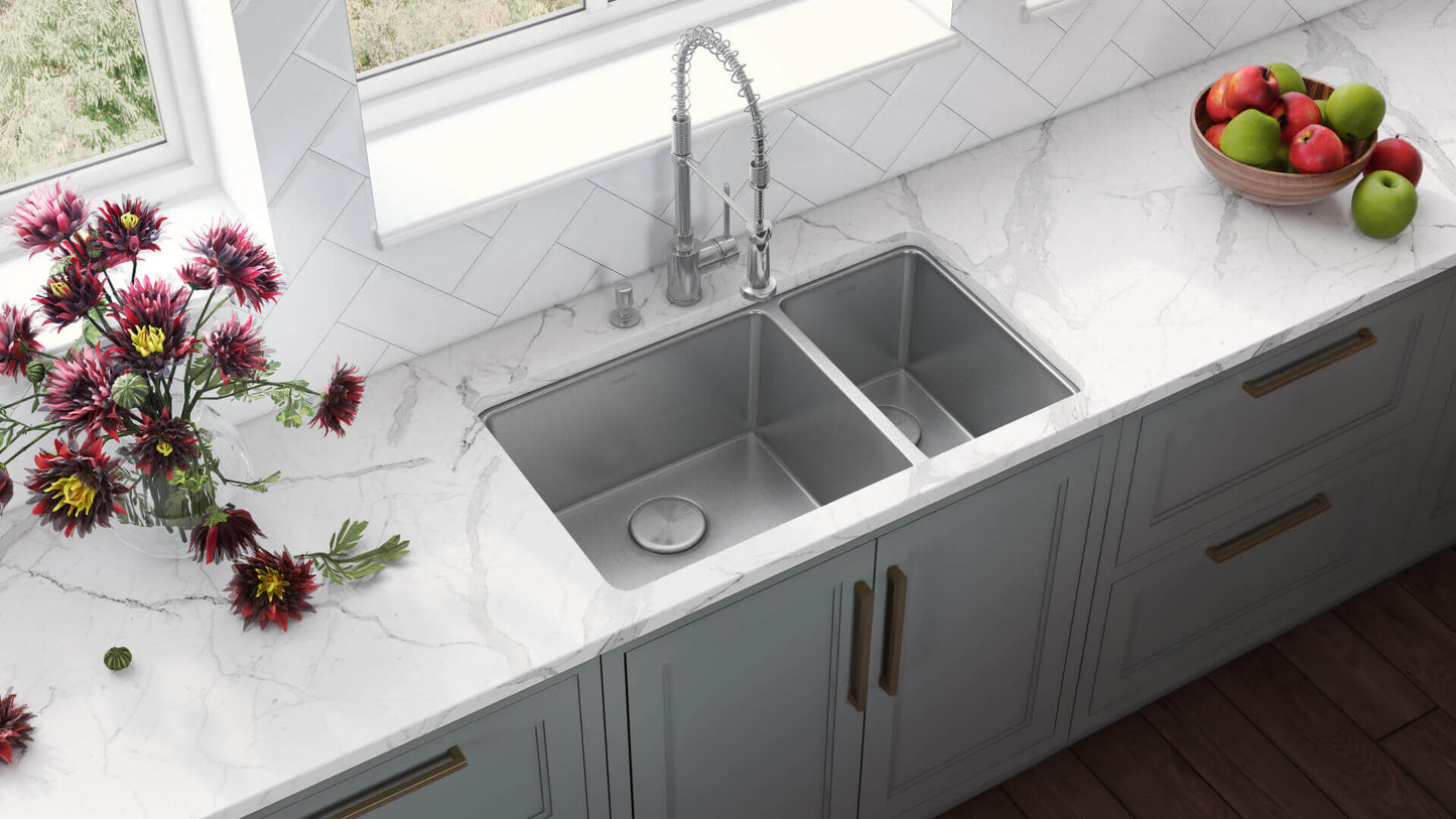 Ruvati 32" Undermount Kitchen Sink 70/30 Double Bowl - RVM5300 installed in a modern kitchen countertop with flowers and fruit.
