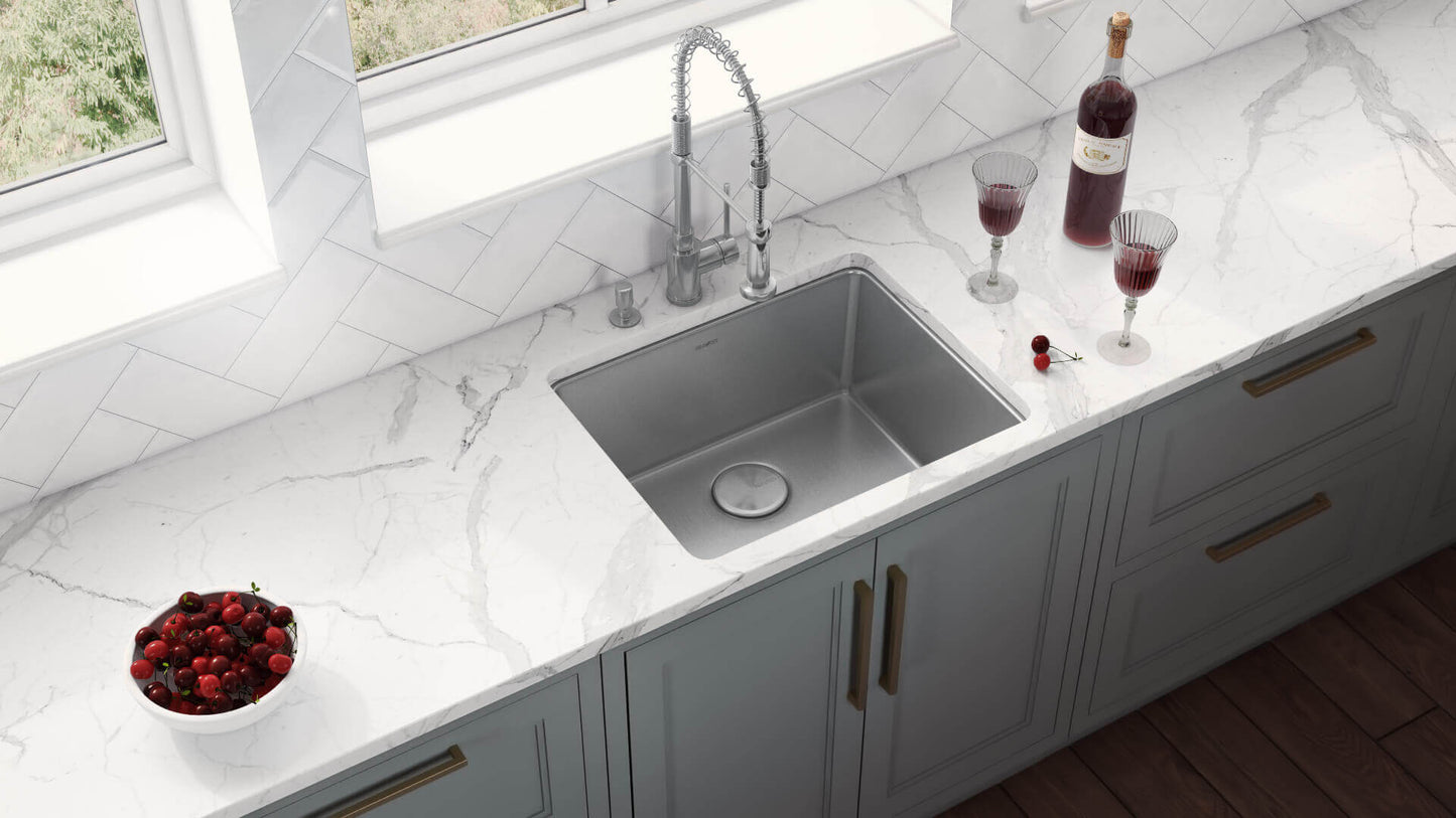 Ruvati 23" Undermount Bar Prep Kitchen Sink Single Bowl - RVM5908 on a marble countertop with wine glasses and a bowl of cherries.