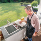 Ruvati Insulated Ice Chest and Outdoor Sink - Man Lifting Lid of Ice Chest in Outdoor Kitchen