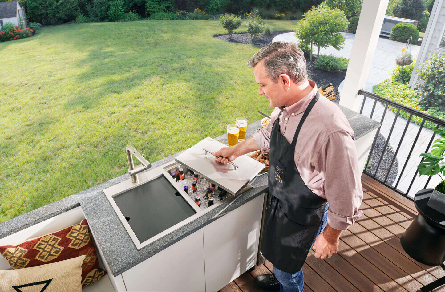 Ruvati Insulated Ice Chest and Outdoor Sink - Man Lifting Lid of Ice Chest in Outdoor Kitchen