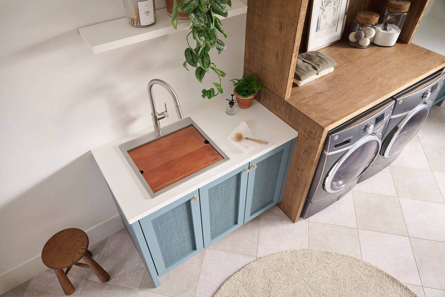 Ruvati 21" Deep Laundry Utility Workstation Sink Topmount - RVU6421 installed in a stylish laundry room setting with modern decor.