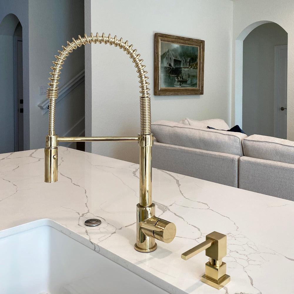 ZLINE Sierra Kitchen Faucet in gold finish installed in a modern kitchen with marble countertop.