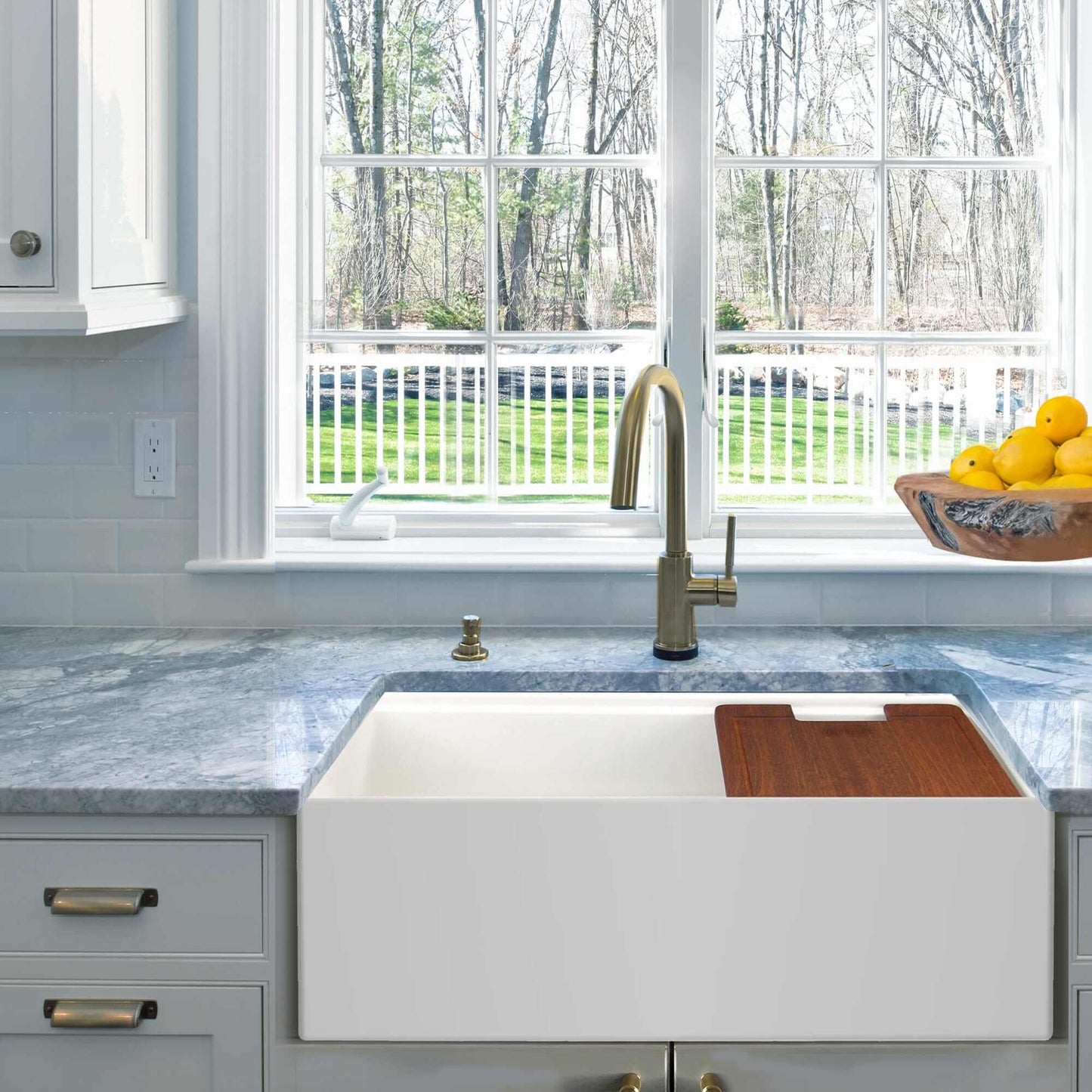 Nantucket 30" Workstation Fireclay Apron Sink Side Drain - T-PS30W displayed in a modern kitchen with a view.