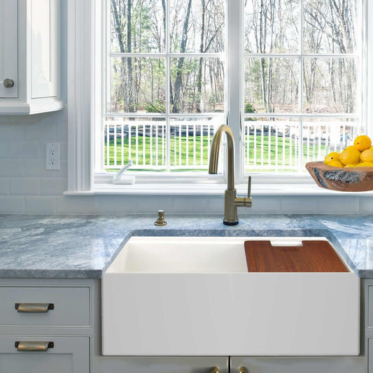 Nantucket 30" Workstation Fireclay Apron Sink Side Drain - T-PS30W displayed in a modern kitchen with a view.