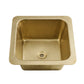 Thompson Traders Tamayo square hammered brass kitchen sink with a matching drain, shown from a top-down perspective on a solid white background.