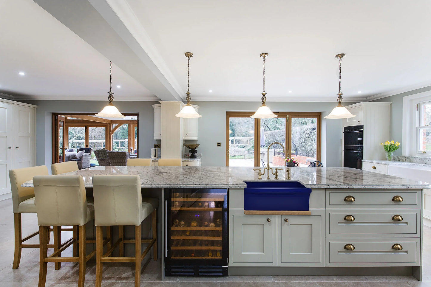 Modern kitchen featuring WHITEHAUS 30" Glencove Fireclay Reversible Sink with elegant cabinetry and lighting.