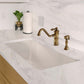 Whitehaus 34" dual mount fireclay kitchen sink with brass faucet and handles on a marble countertop.