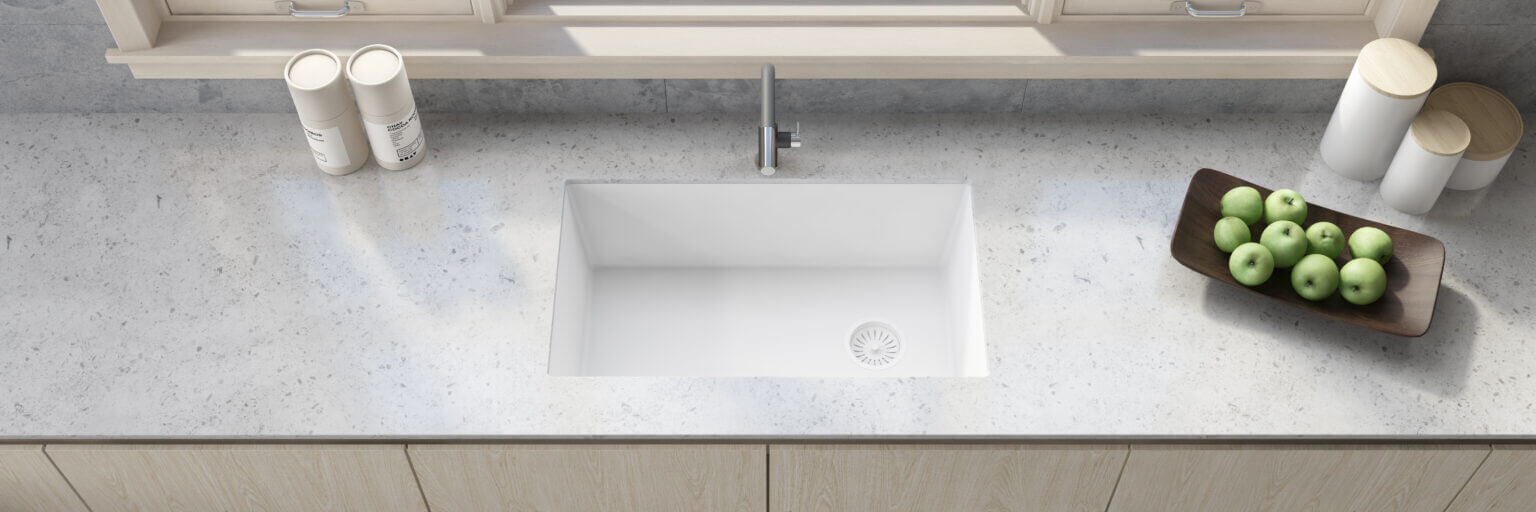 Ruvati 32" epiGranite undermount single bowl kitchen sink in Arctic White on a modern countertop with apples.