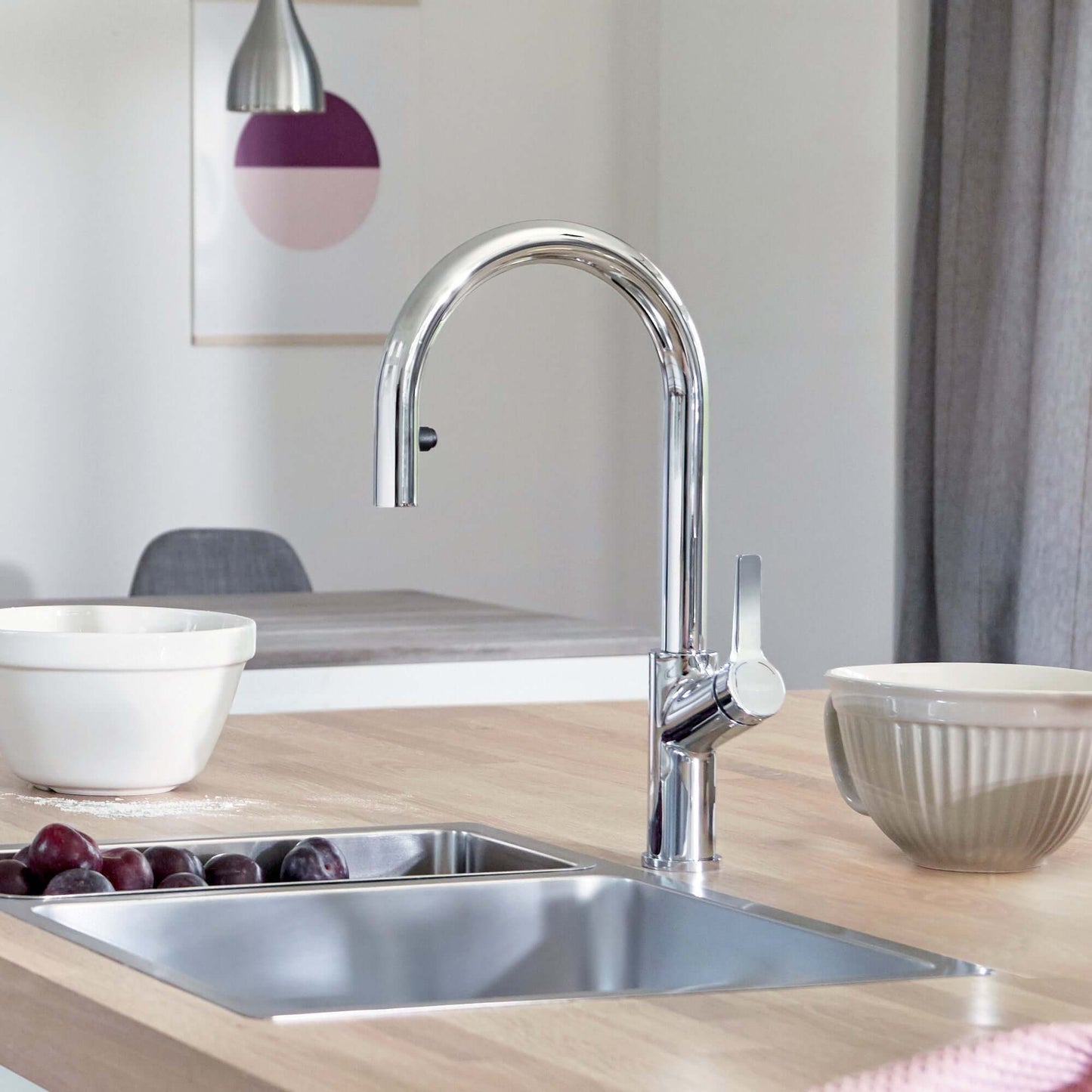 BLANCO Urbena Pull-Down Dual-Spray Kitchen Faucet in a modern kitchen setting with a stainless steel sink.
