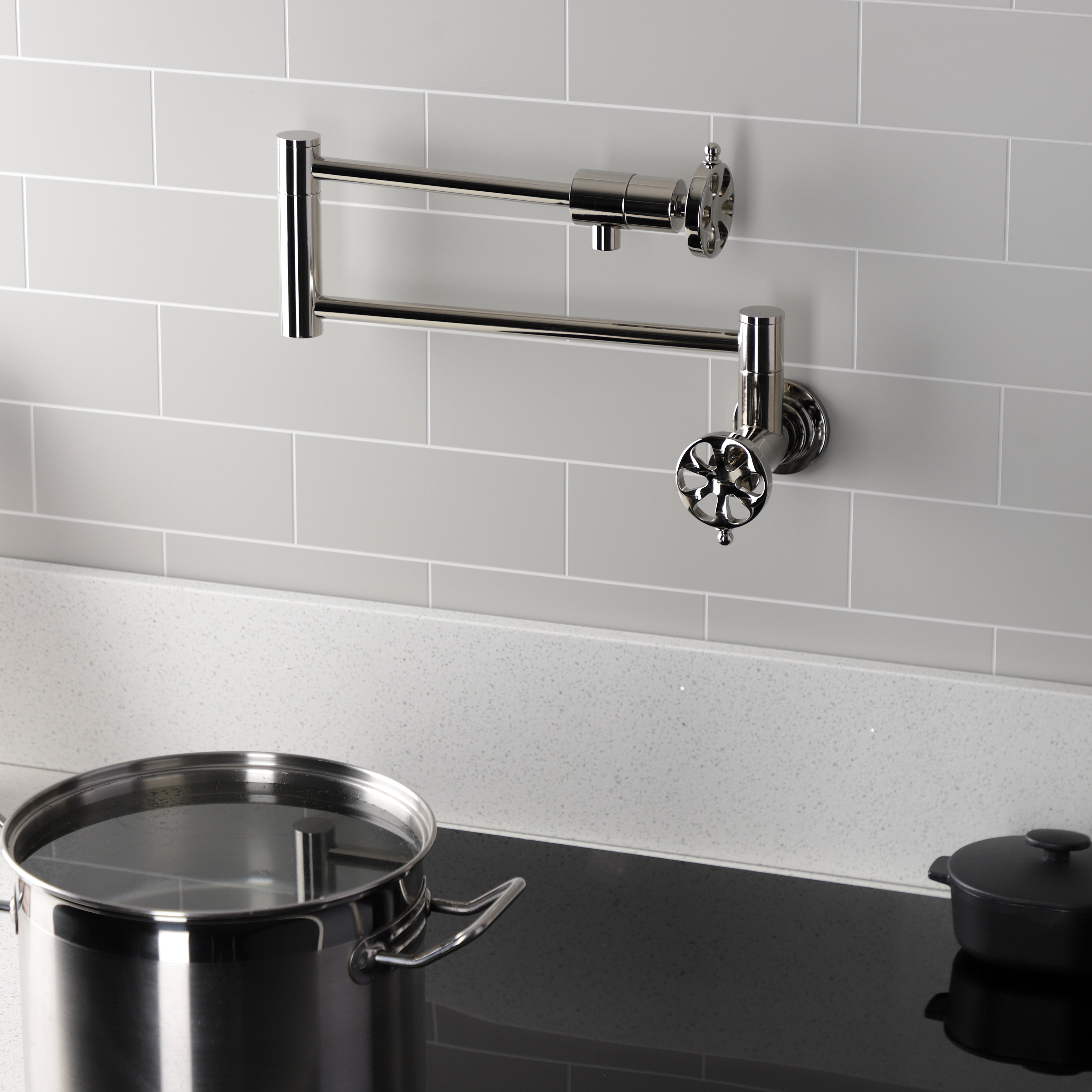 Kingston Brass KS4103RX Belknap Wall Mount Pot Filler Faucet, Antique Brass with swing arms and pot.