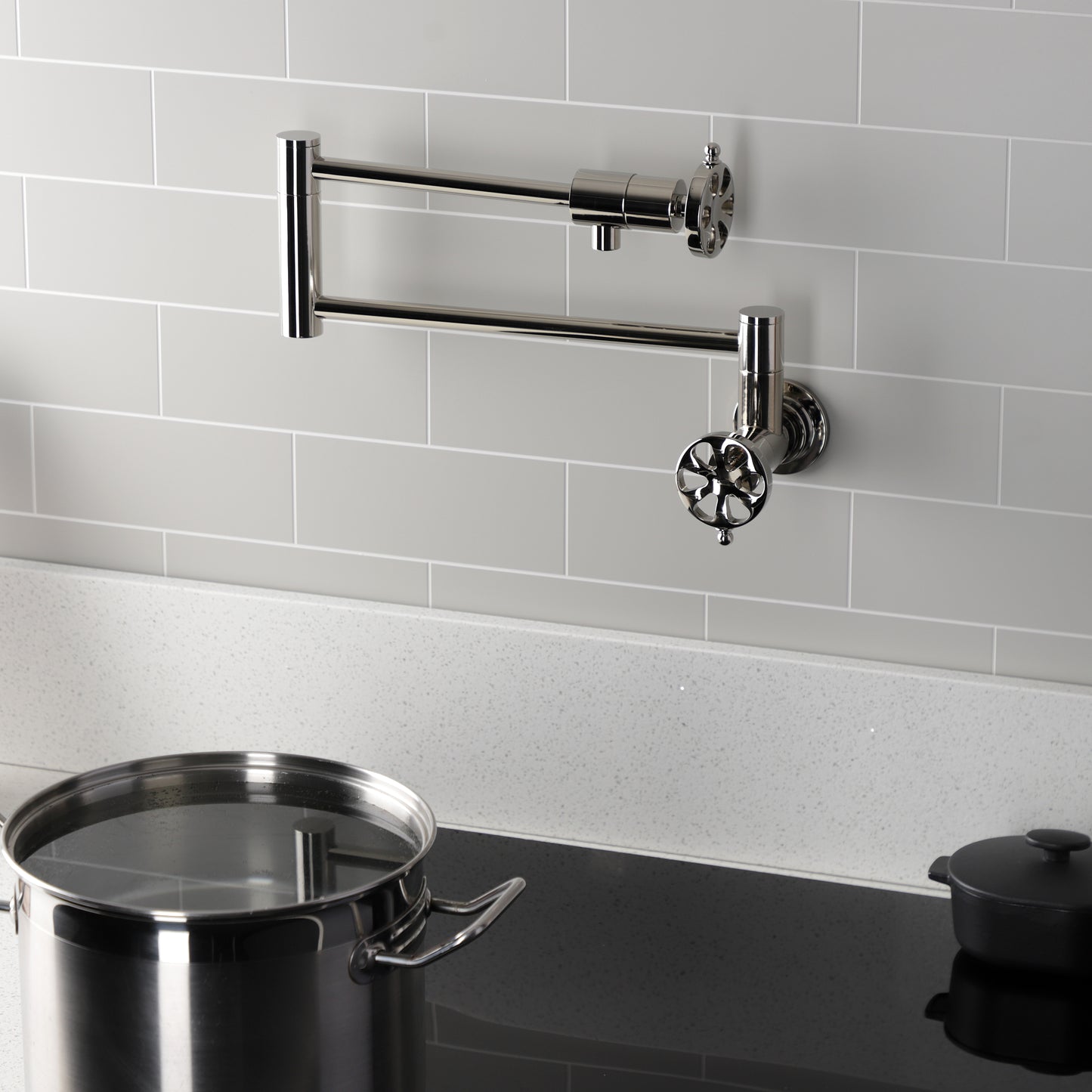 Kingston Brass KS4103RX Belknap Wall Mount Pot Filler Faucet, Antique Brass with swing arms and pot.