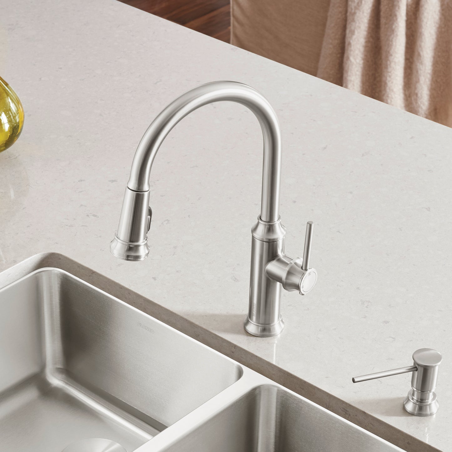 BLANCO Empressa High Arc Pull-Down Dual-Spray Kitchen Faucet on a countertop with dual sinks.