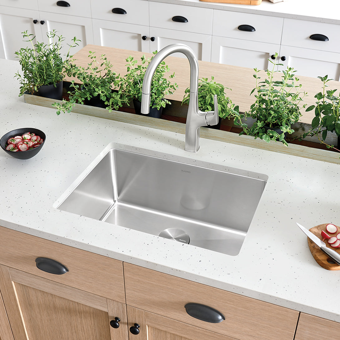 BLANCO Cuvee R15 25" Single Bowl Undermount Stainless Steel Kitchen Sink in modern kitchen with plants and utensils.