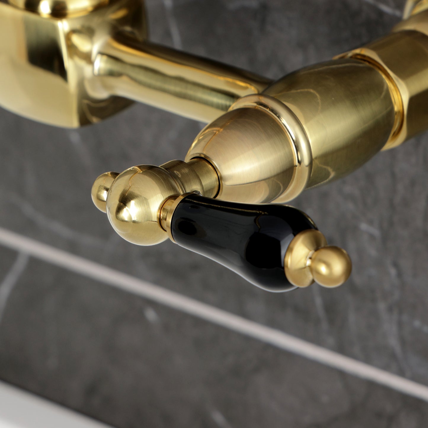 Kingston KS1263PKL Duchess Two-Handle Wall Mount Bridge Kitchen Faucet, Antique Brass with black porcelain handles