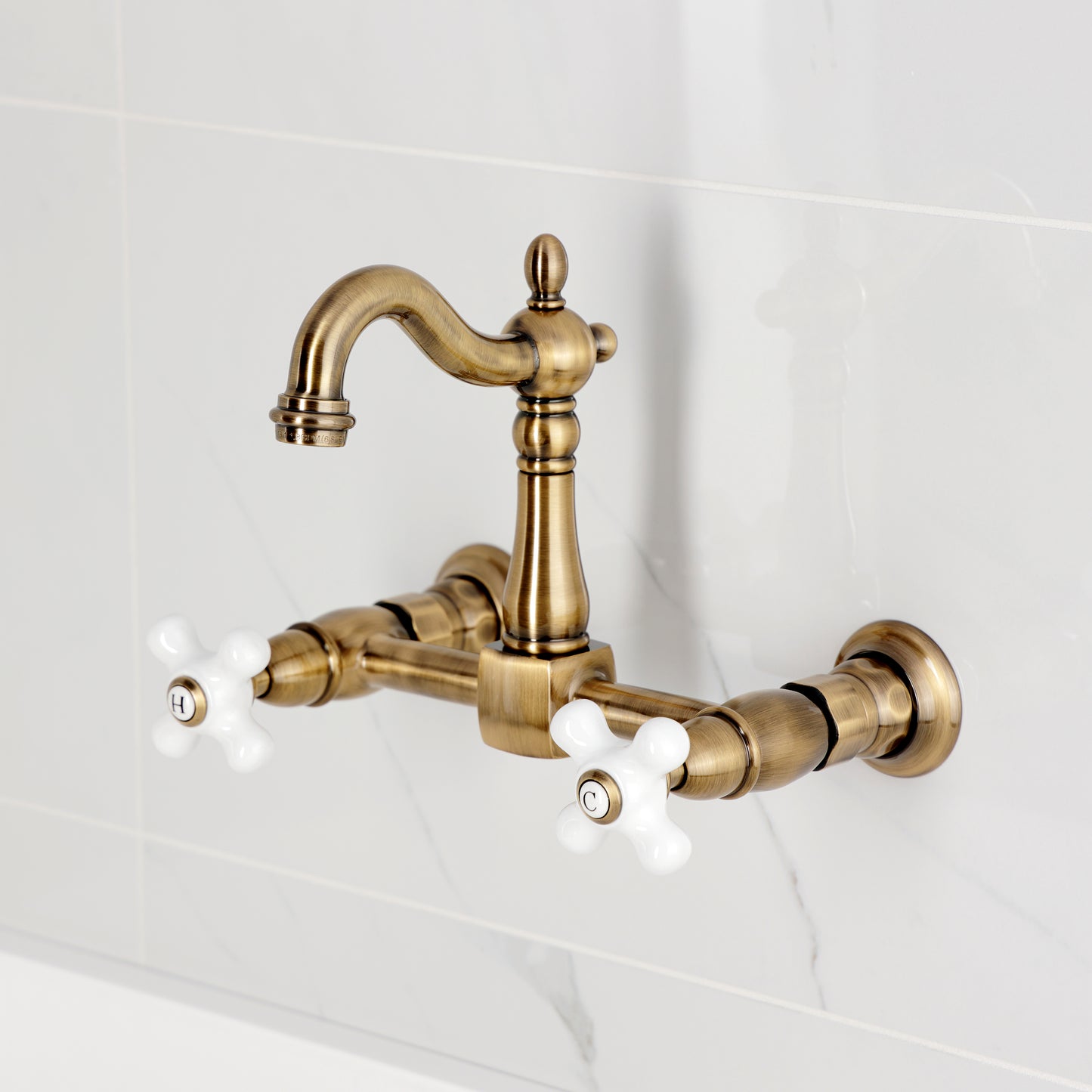 Kingston KS2443PX Heritage Two-Handle Wall Mount Bridge Kitchen Faucet, Antique Brass with porcelain cross handles