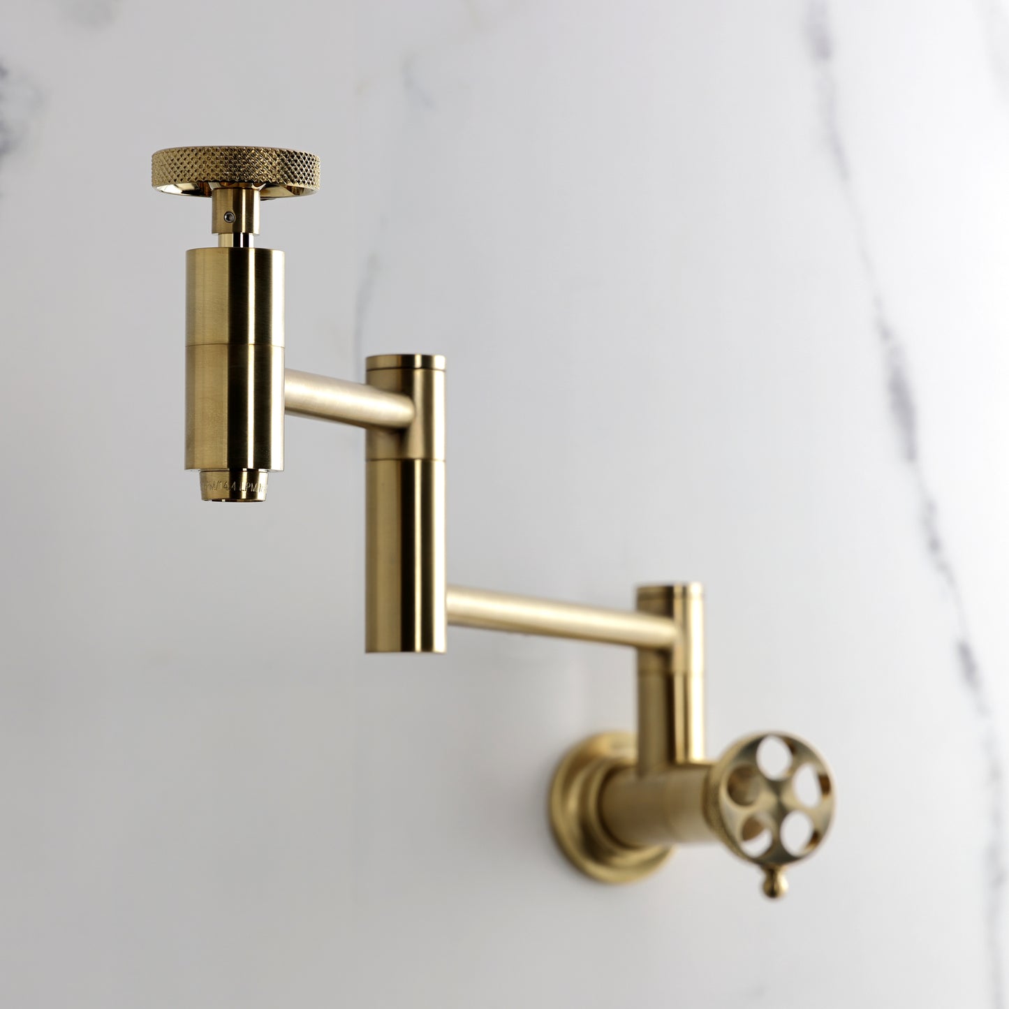 Kingston Brass KS8103RKX Webb Wall Mount Pot Filler Faucet with Knurled Handle, Antique Brass in a stylish kitchen setting.