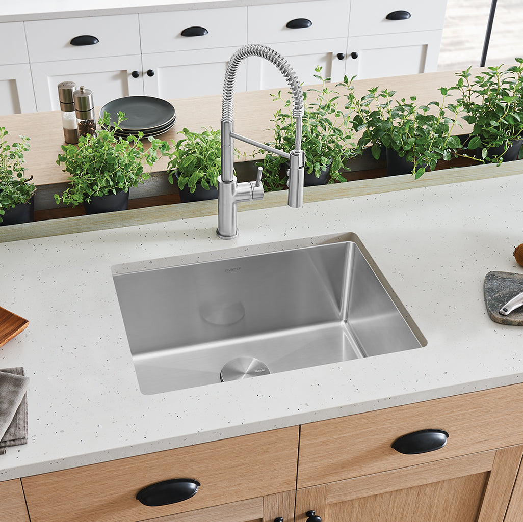 BLANCO Cuvee R15 25" Single Bowl Undermount Stainless Steel Kitchen Sink installed in a modern kitchen with plants.
