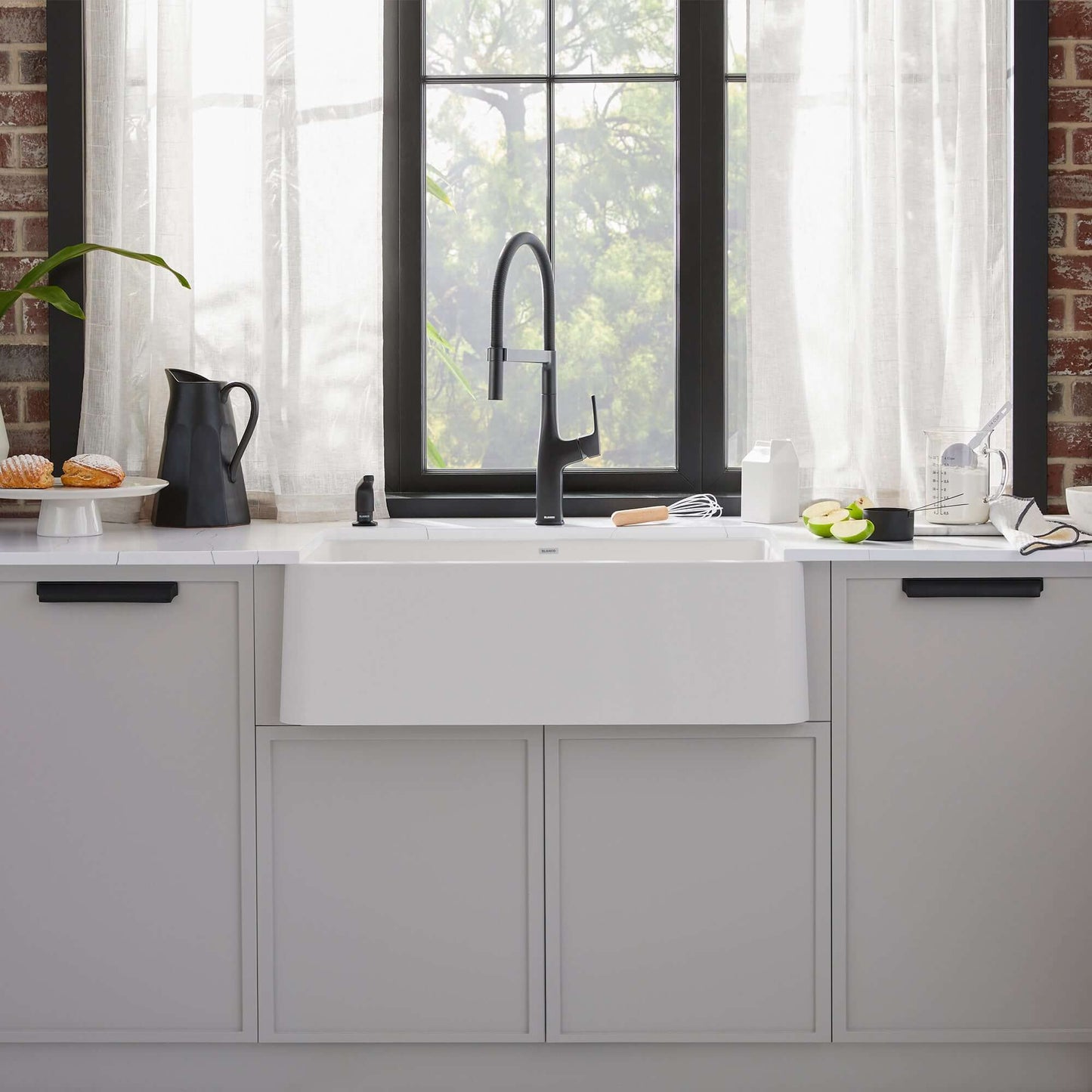 BLANCO Ikon SILGRANIT 33" Single Bowl Apron-Front Farmhouse Sink with modern faucet in stylish kitchen setting.