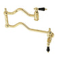 Kingston Brass KS2107PKL Duchess Wall Mount Pot Filler Faucet, Brushed Brass with black porcelain handles.