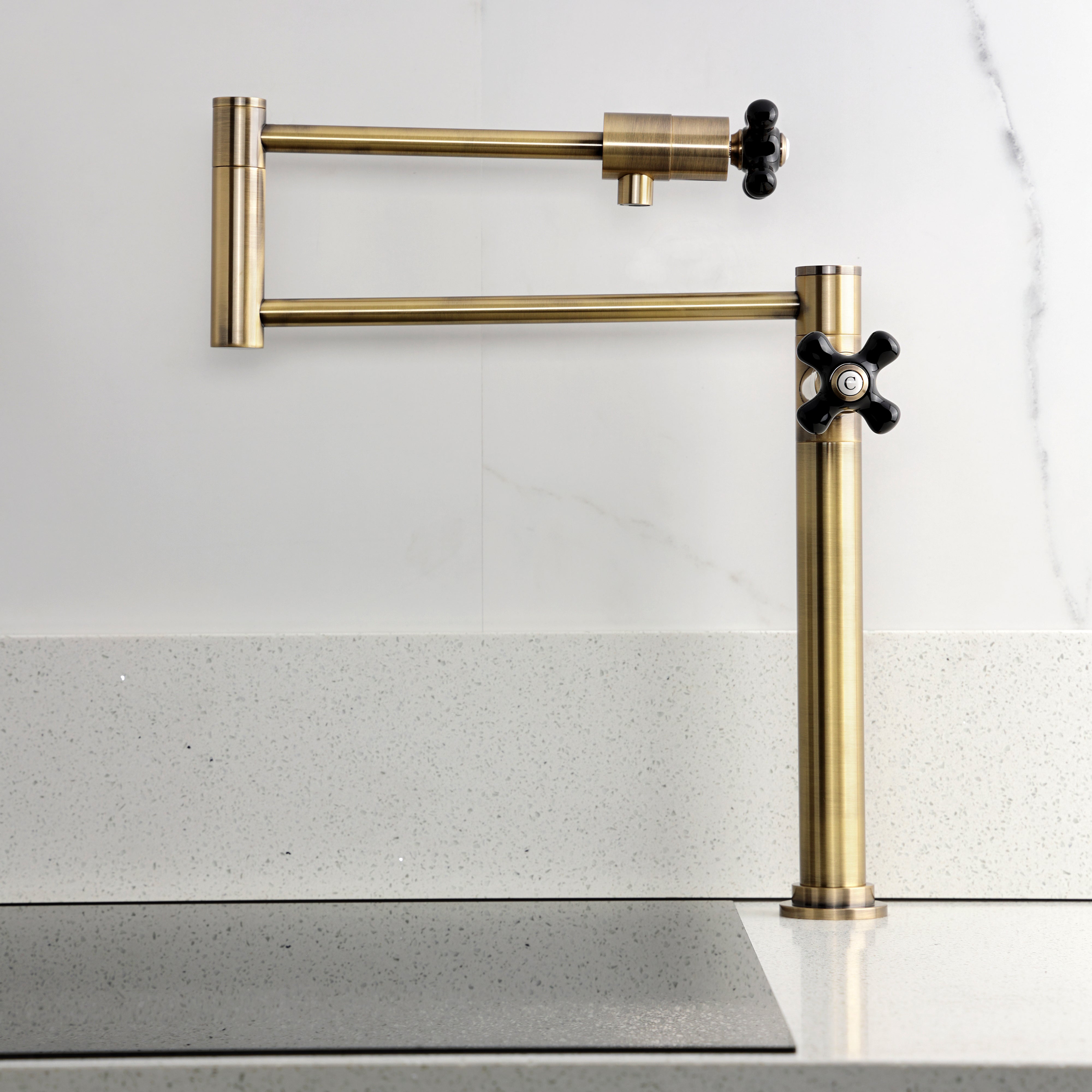 Kingston Brass KS4703PKX Duchess Deck Mount Pot Filler Faucet, Antique Brass mounted on a countertop