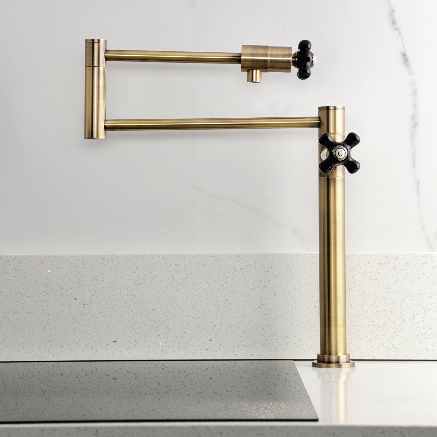 Kingston Brass KS4703PKX Duchess Deck Mount Pot Filler Faucet, Antique Brass mounted on a countertop