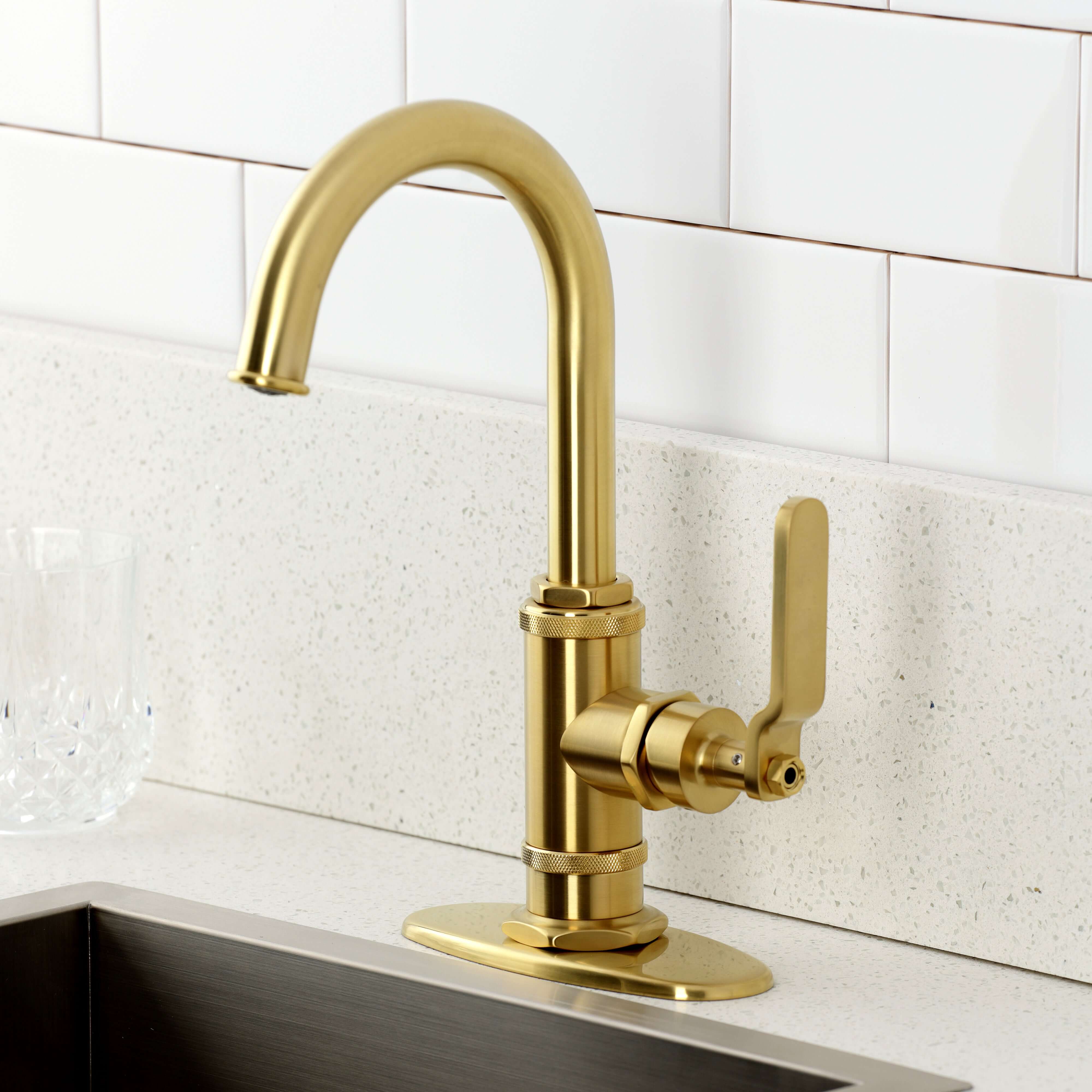 Kingston Brass KSD8503KL Whitaker Single-Handle Bar Faucet, Antique Brass in a modern kitchen setting.