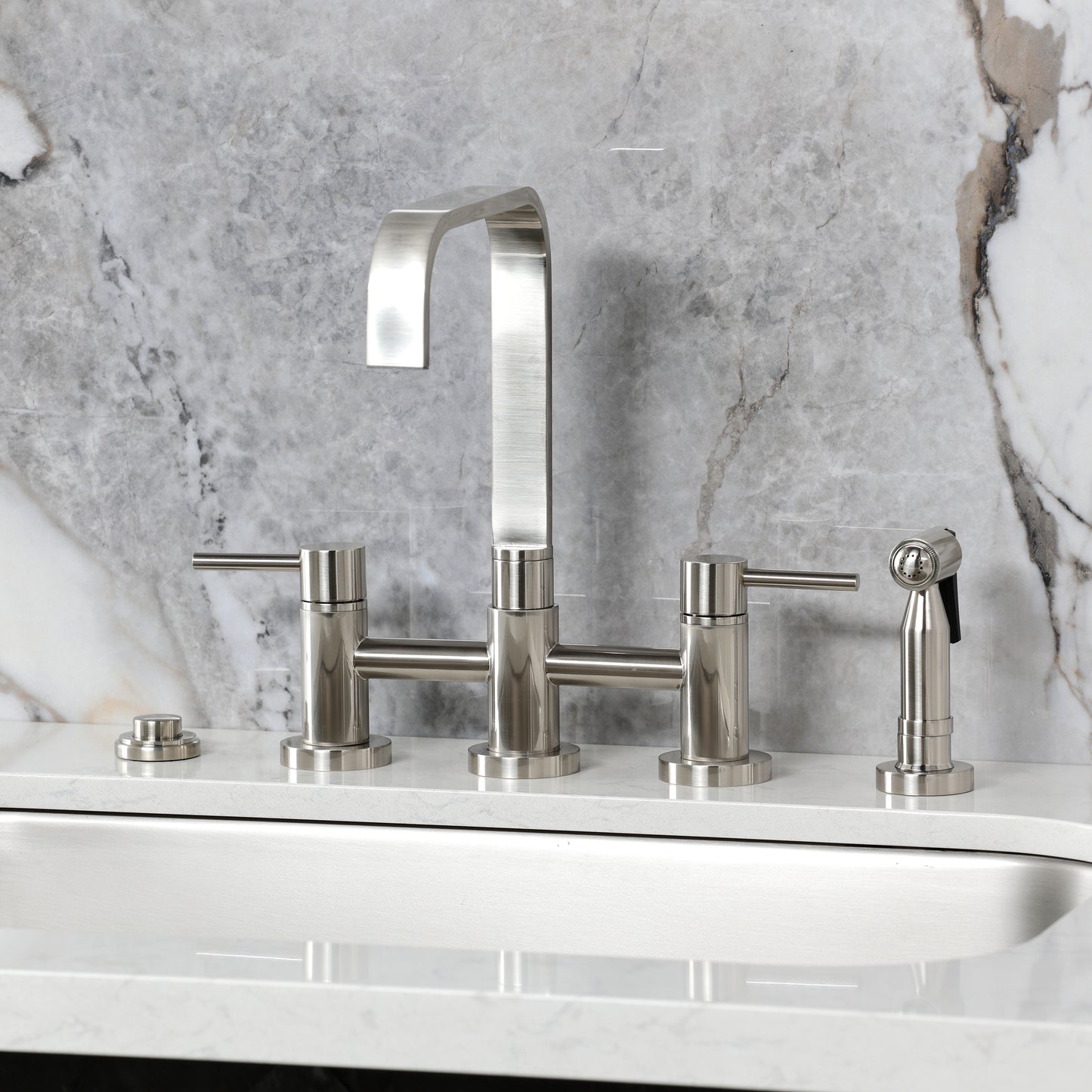 Kingston KS8257DLBS Concord Bridge Kitchen Faucet with Brass Sprayer, Brushed Brass on marble surface