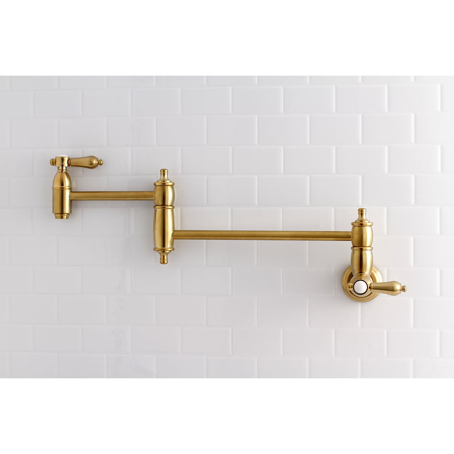 Kingston Brass KS3103BAL Heirloom Wall Mount Pot Filler Faucet, Antique Brass on white tiled wall