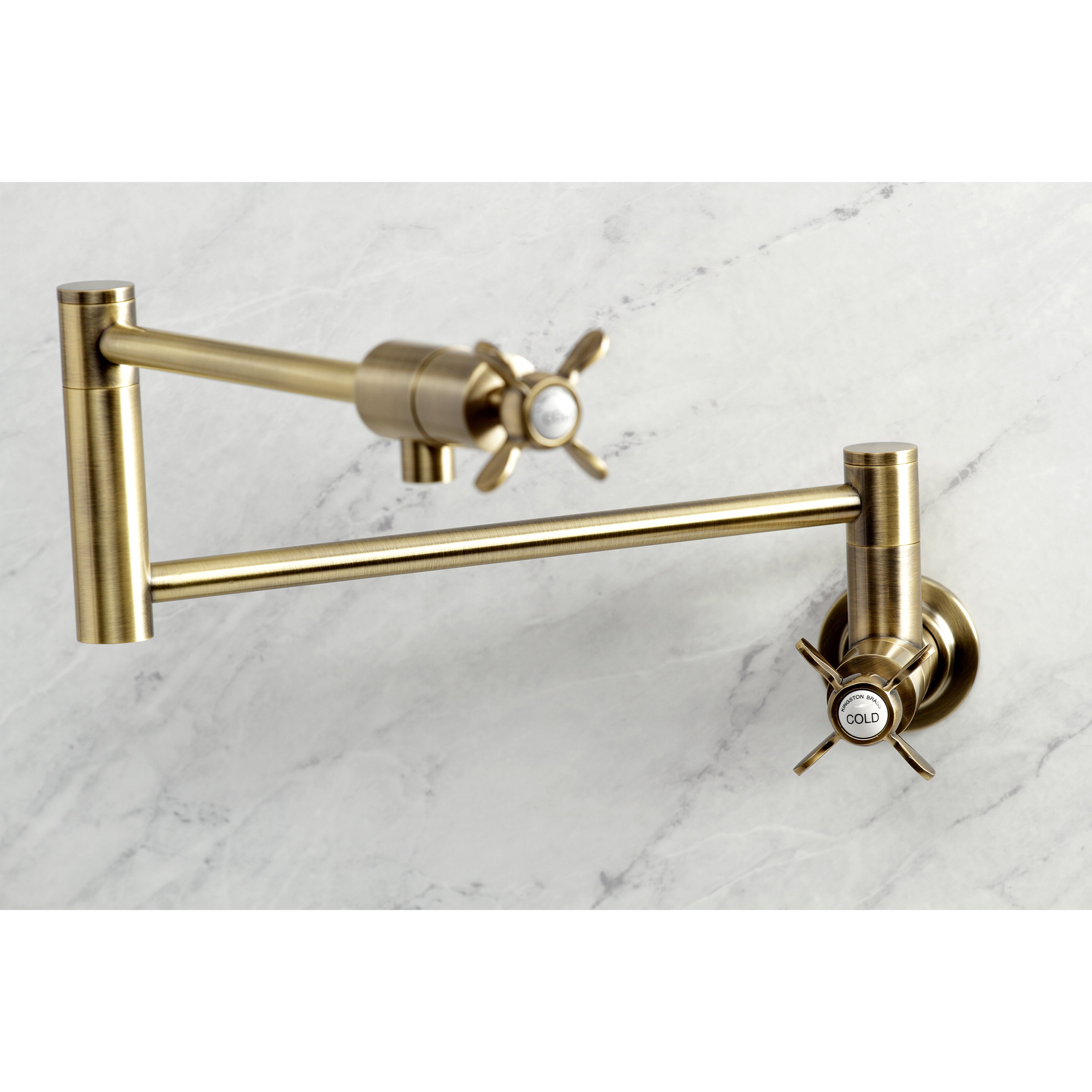 Kingston Brass KS4103BEX Essex Wall Mount Pot Filler Faucet, Antique Brass close-up view on marble background.