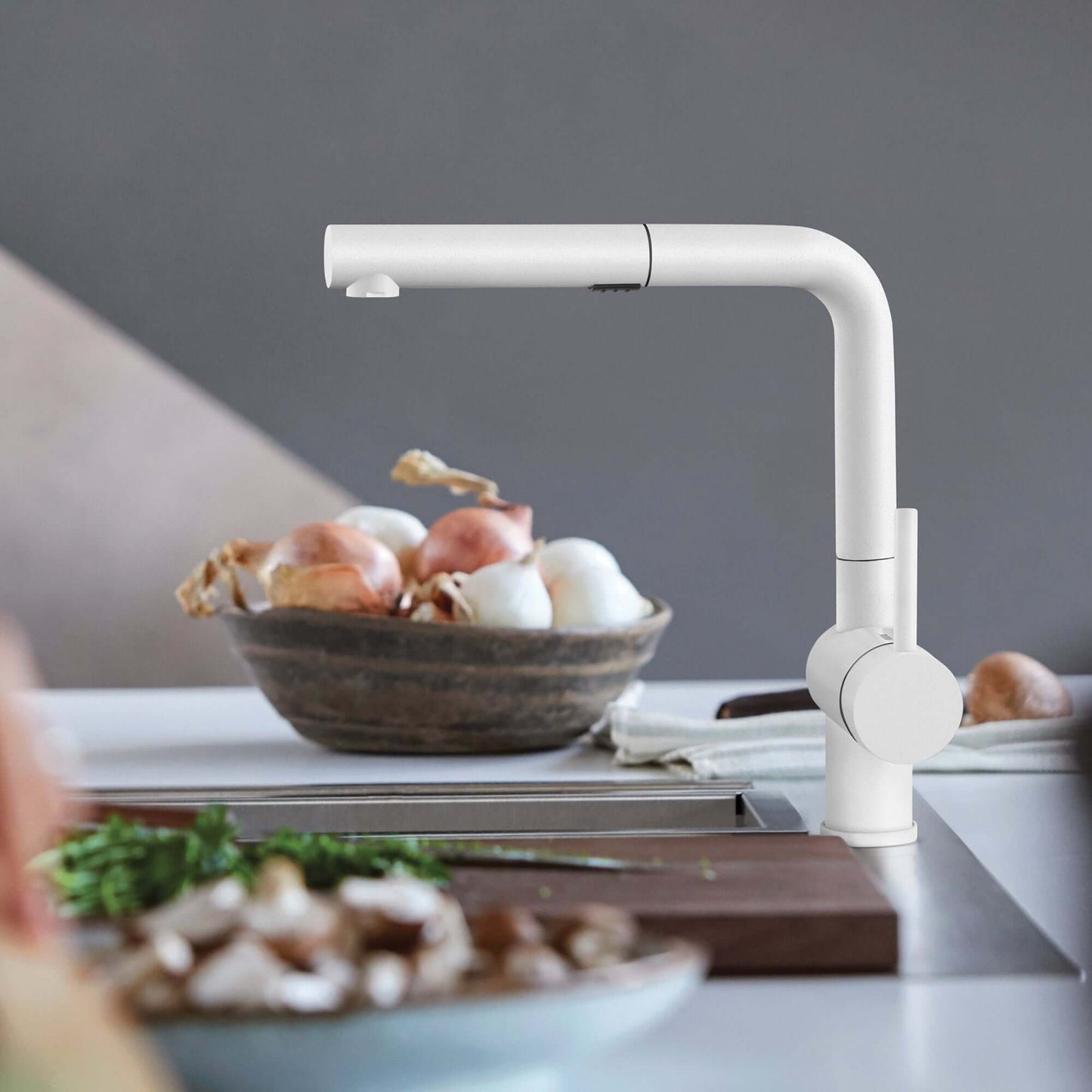BLANCO Linus Low Arc Pull-Out Dual-Spray Kitchen Faucet - White in modern kitchen setting with fresh ingredients.