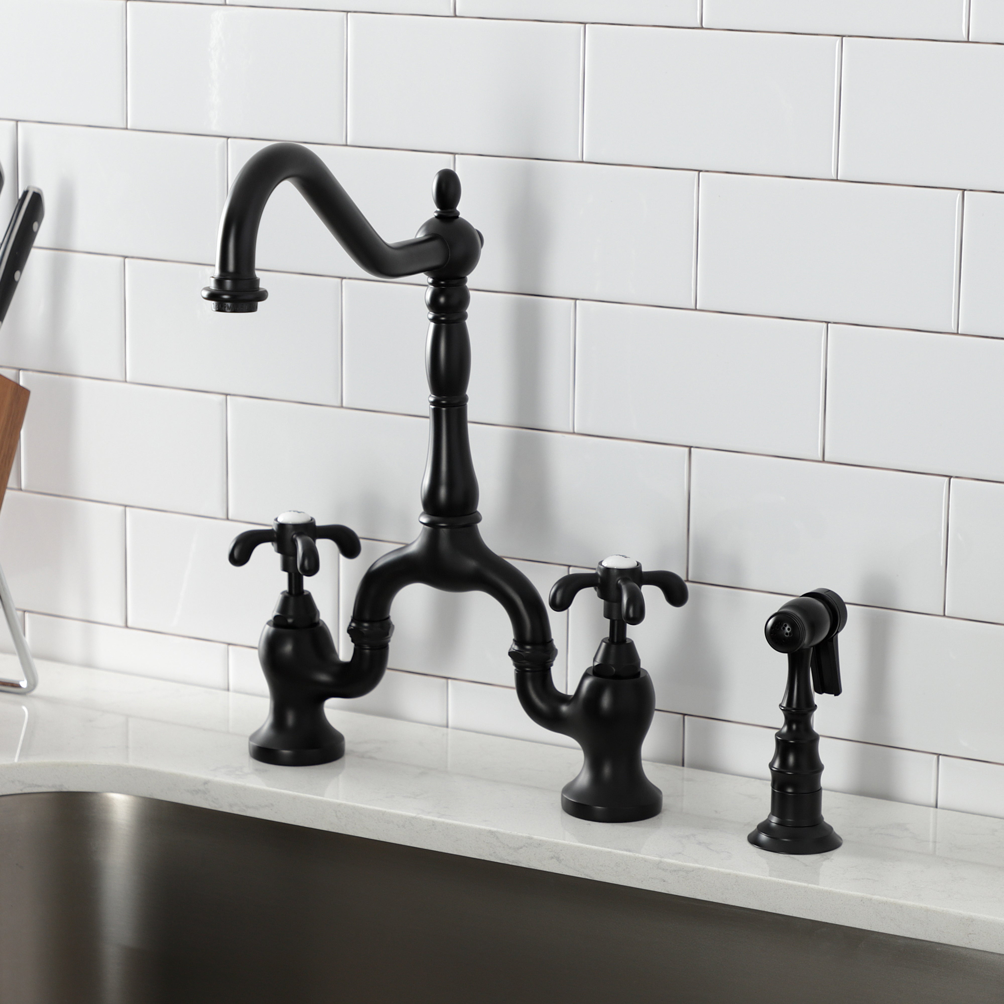 Kingston KS7753TXBS French Country Bridge Kitchen Faucet with Brass Sprayer, Antique Brass in sleek black finish.