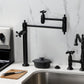 Kingston Brass KS3703AX Restoration Deck Mount Pot Filler Faucet, Antique Brass in a modern kitchen setting.
