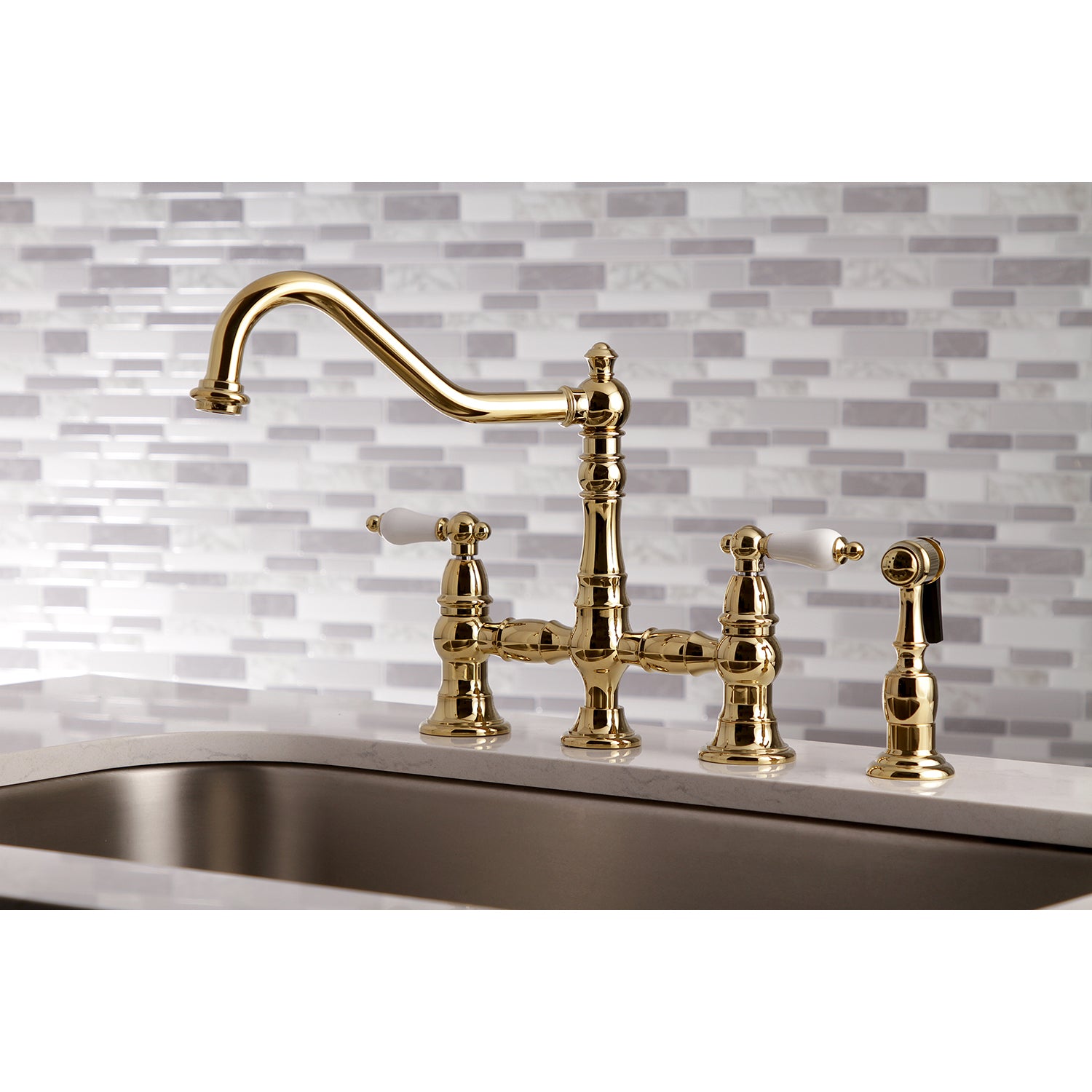 Kingston KS3277PLBS Restoration Bridge Kitchen Faucet with Brass Sprayer, Brushed Brass on a stylish kitchen countertop.