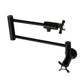 Kingston Brass KS4103BEX Essex Wall Mount Pot Filler Faucet, Antique Brass with dual levers and foldable arms.
