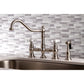 Kingston KS3277PXBS Restoration Bridge Kitchen Faucet with Brass Sprayer, Brushed Brass on a kitchen sink.