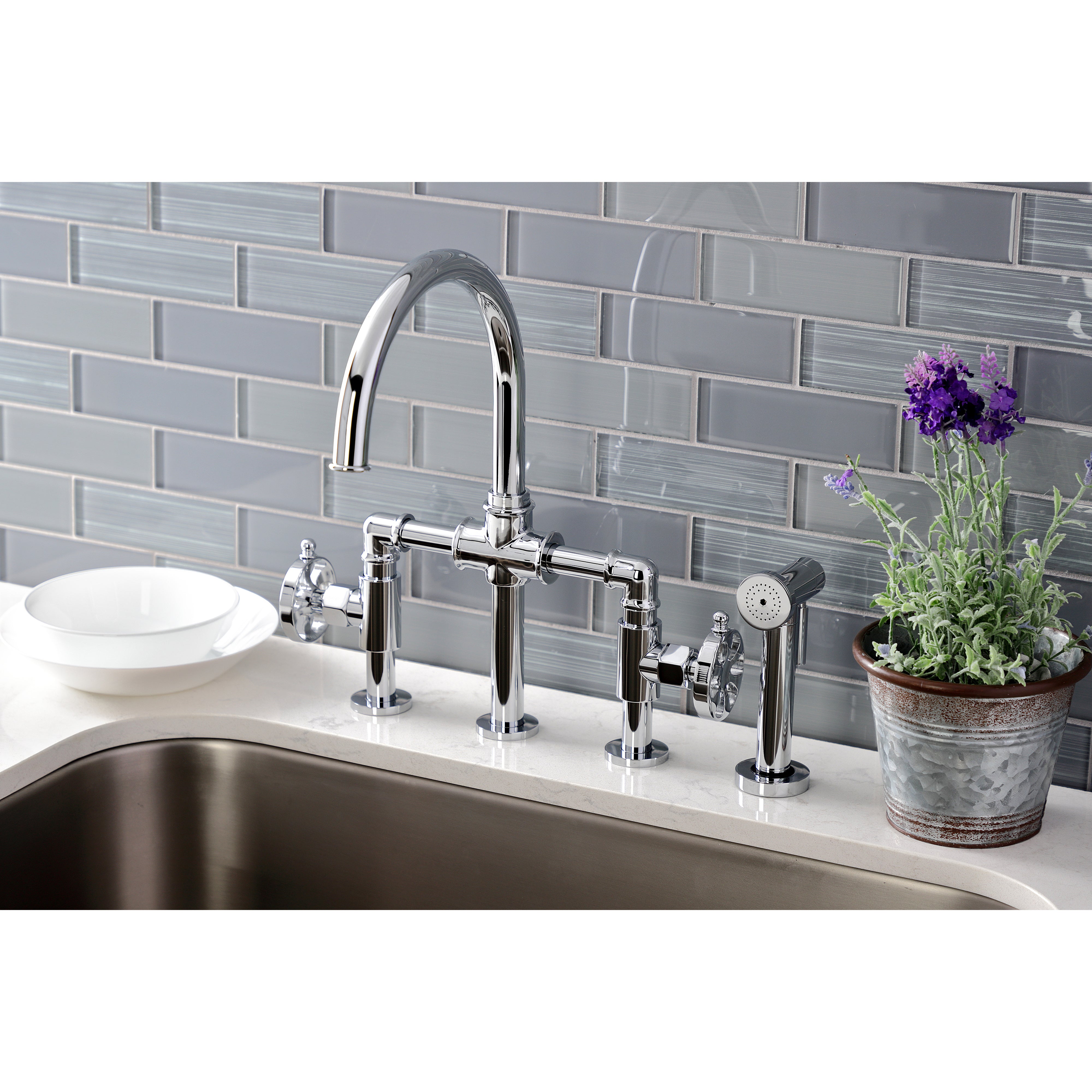 Kingston KS2333RX Belknap Industrial Style Bridge Kitchen Faucet with Brass Sprayer, Antique Brass in a modern kitchen setting.