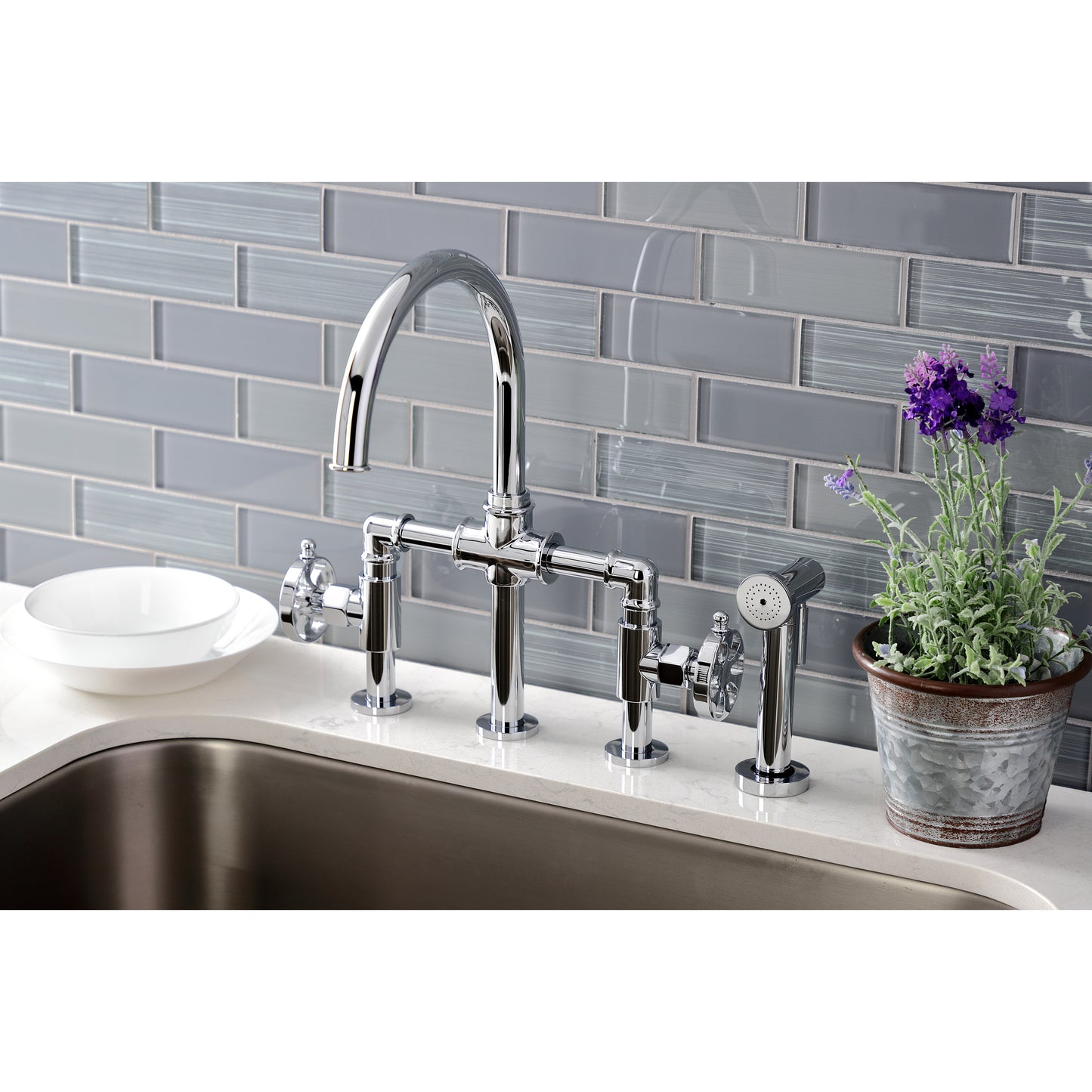 Kingston KS2333RX Belknap Industrial Style Bridge Kitchen Faucet with Brass Sprayer, Antique Brass in a modern kitchen setting.