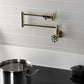Kingston Brass KS4103RX Belknap Wall Mount Pot Filler Faucet, Antique Brass above a metal pot.