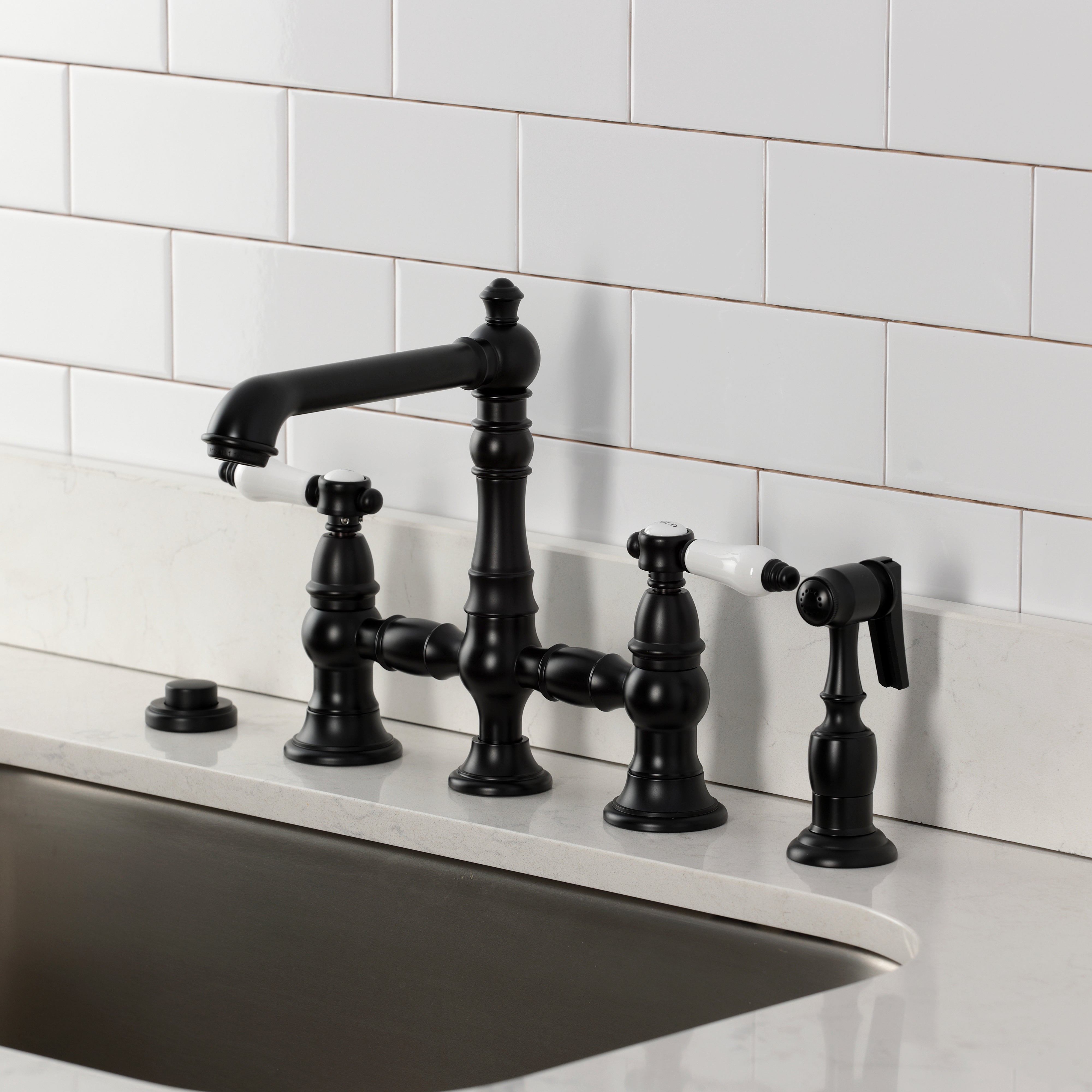 Kingston KS7277BPLBS Bel-Air Bridge Kitchen Faucet with Brass Sprayer, Brushed Brass shown in black finish.